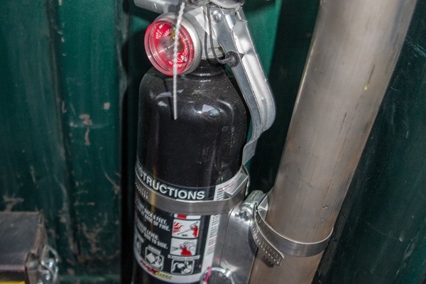 fire extinguisher mounted on a vehicle roll bar