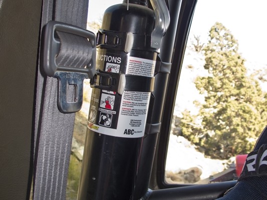 fire extinguisher mounted on a truck roll bar