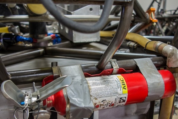 fire extinguisher mounted on a race car roll bar