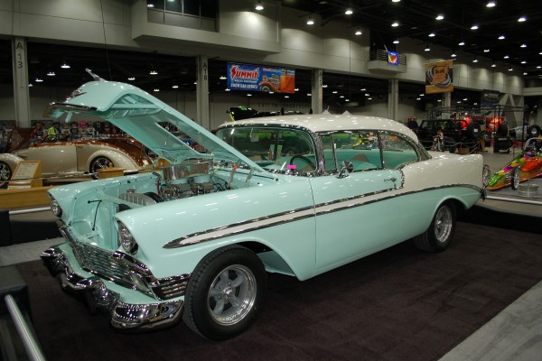blue 1956 chevy bel air on display in indoor car show