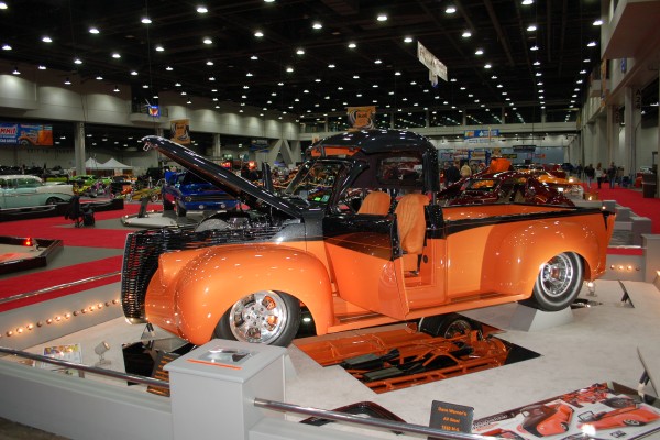 customized pickup truck hot rod on display in indoor car show