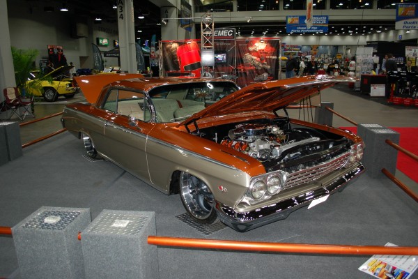 lowered custom chevy impala on display in indoor car show