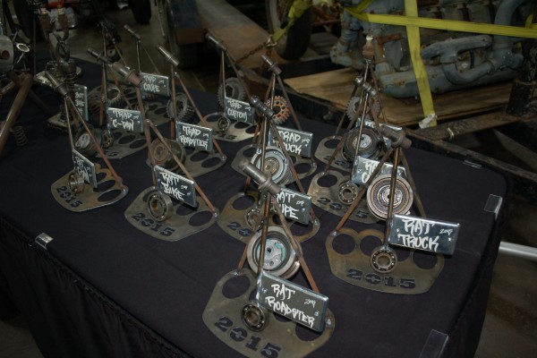 rat rod trophies on display in indoor car show