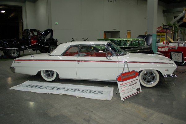 white lowered chevy impala coupe from the early 1960s