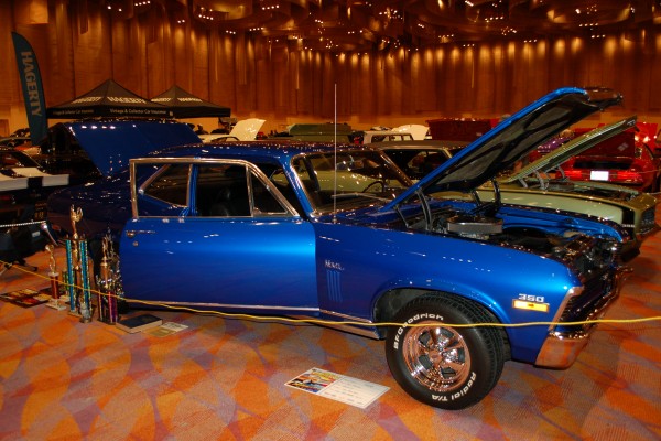blue chevy nova ss 350 on display in indoor car show