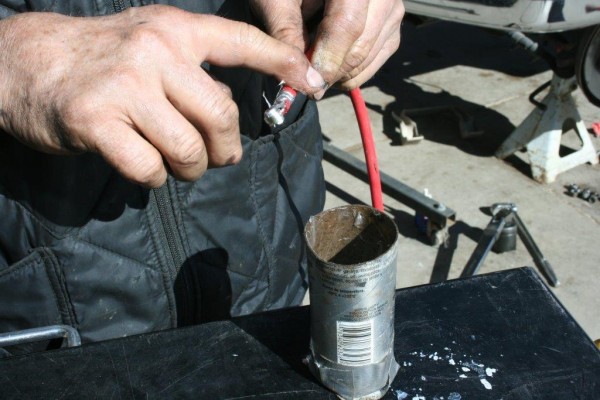 man applying dielectric grease to spark plug boot terminal
