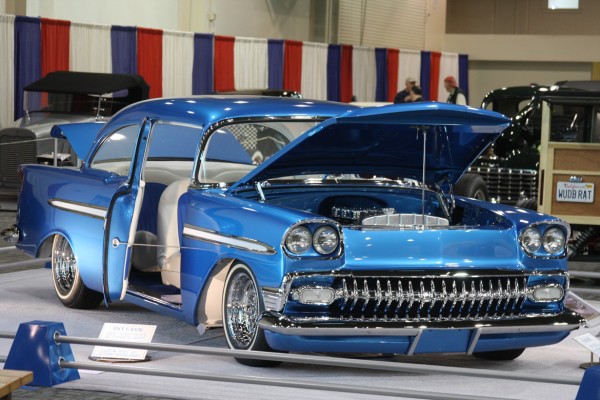 customized 1956 chevy coupe on display at car show