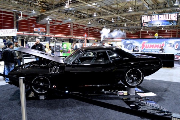 Black Plymouth Barracuda on display at indoor car show