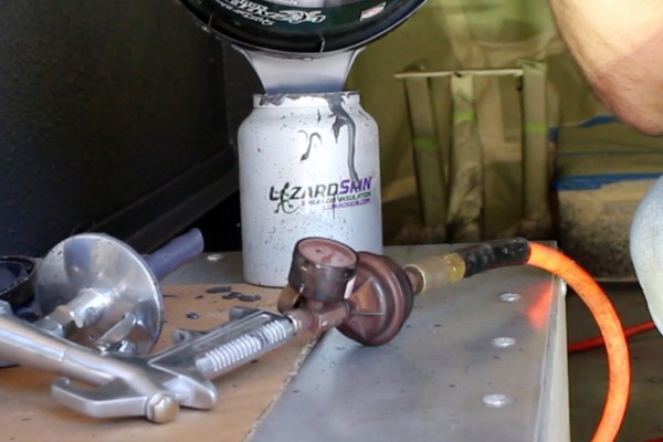 pouring lizardskin coating into a spray gun cup