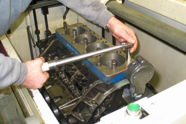 installing deck plates on an engine in a machine shop