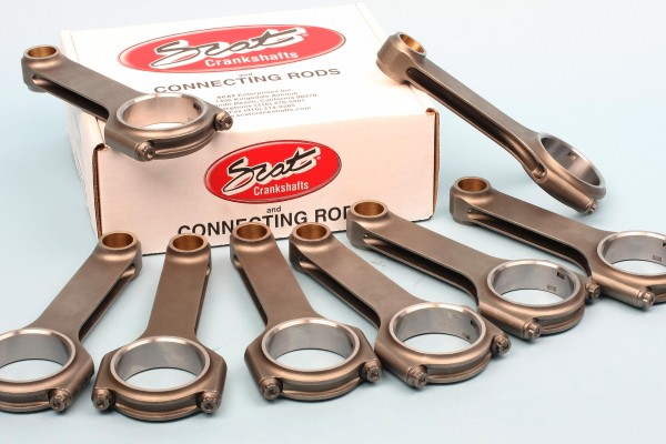 collection of piston connecting rods on a table