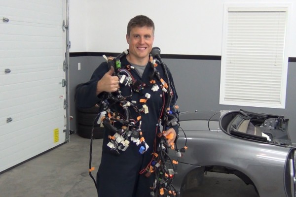 man draped in an automotive wiring harness