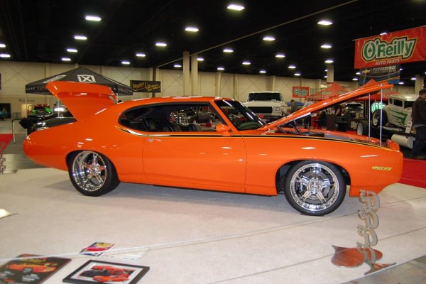 orange pontiac gto muscle car at indoor car show