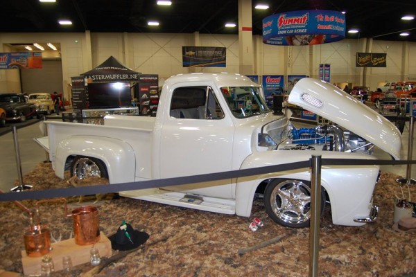 white vintage truck at indoor car show