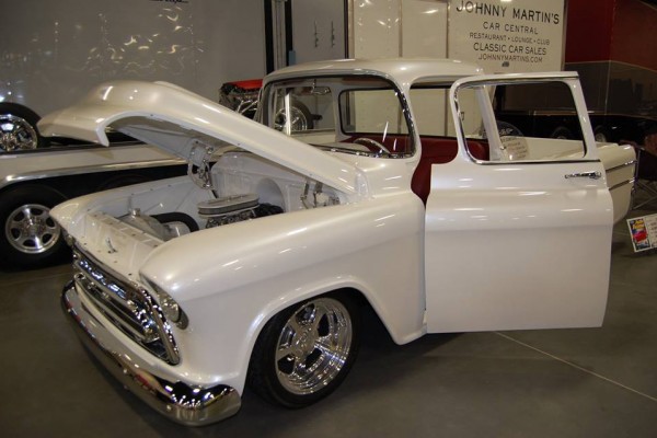 white custom chevy pickup truck at indoor car show