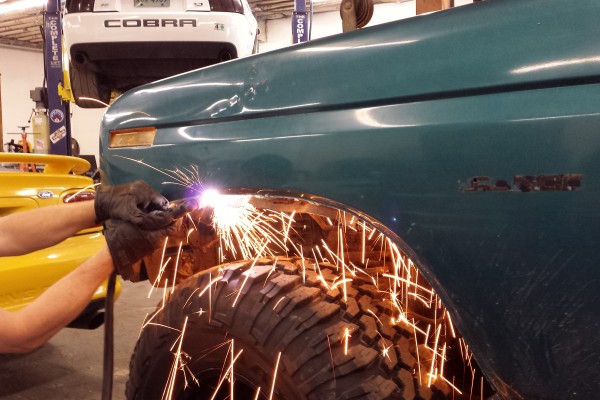 man cutting fenders for a ford bronco off road build project