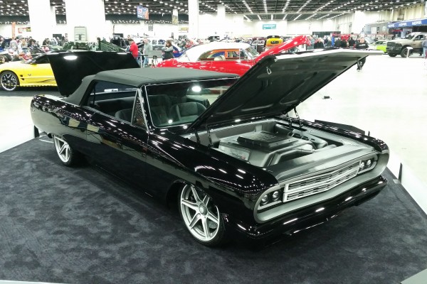 custom chevy chevelle convertible on display at indoor car show