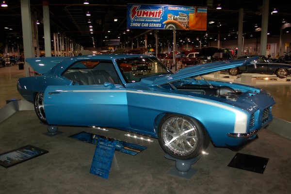 blue customized chevy camaro at a car show