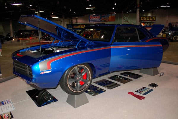 custom blue chevy camaro on display at indoor car show