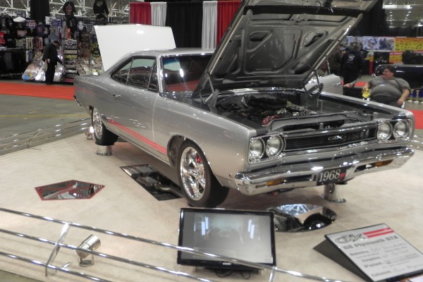silver 1968 plymouth gtx coupe on display at indoor car show