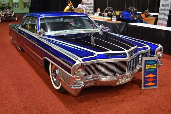 lowered customized Cadillac coupe on display at indoor car show