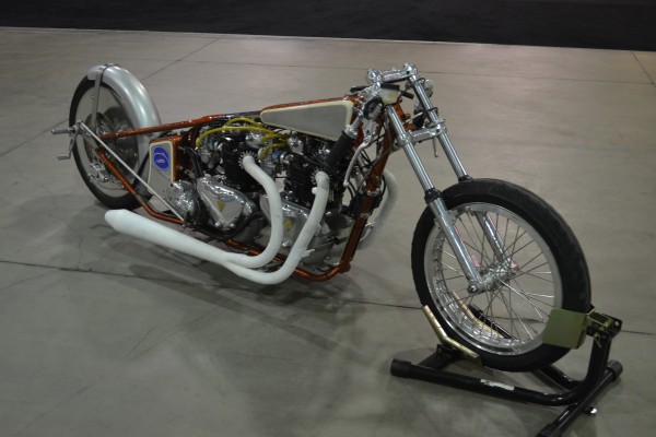 bobber v twin motorcycle on display at indoor car show