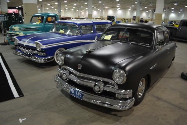 old ford cars and trucks at indoor car show