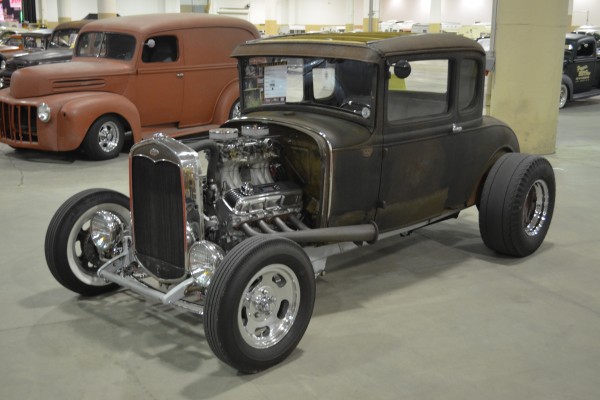 ford five window hotrod on display at indoor car show