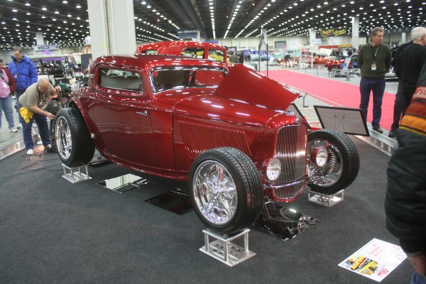 vintage red ford three window hotrod on display at indoor car show