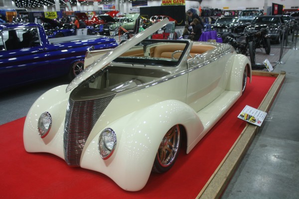 cusomt hot rod coupe on display at indoor car show
