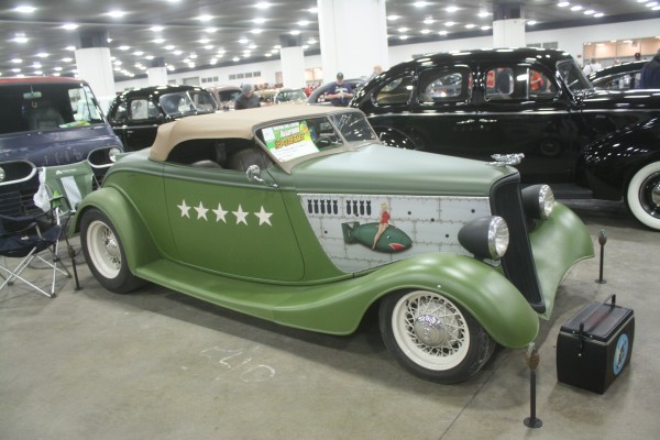 army air corps-themed hot rod roadster on display at indoor car show