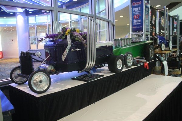 custom hotrod coffin on display at indoor car show