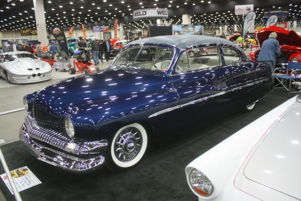 lowered custom coupe on display at indoor car show