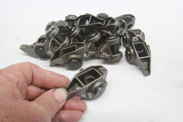 assortment of old gm ls rocker arms in a pile