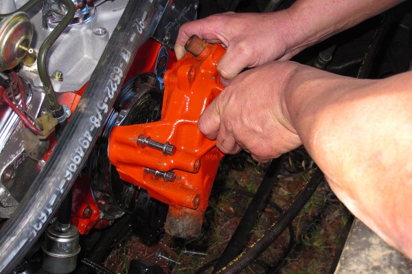 removing a water pump from the front of a v8 engine