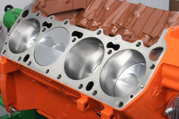 an engine with cylinder head removed to reveal piston bank