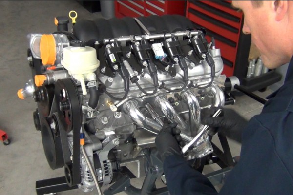 man fitting headers onto an ls engine