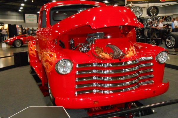 customized vintage chevy truck displayed at indoor car show