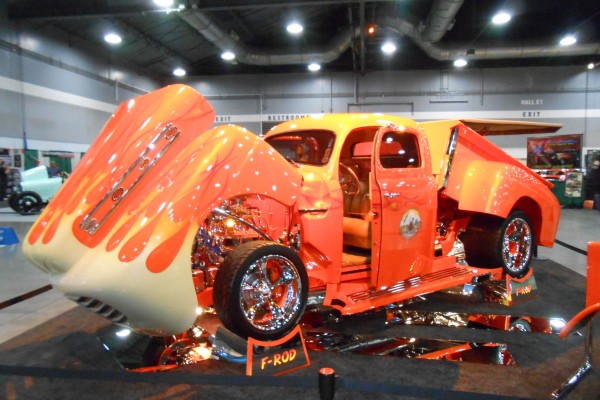 wild customized ford truck displayed at indoor car show