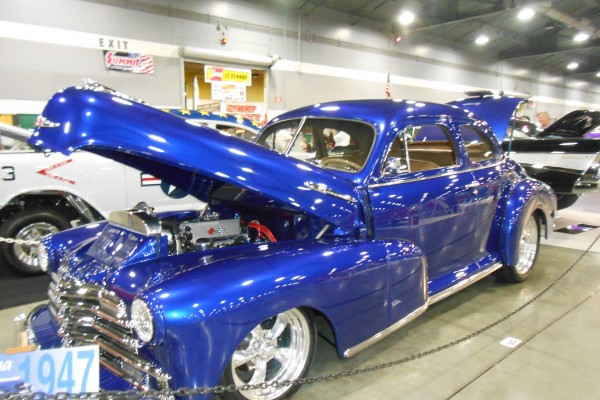 1947 Chevy hot rod coupe displayed at indoor car show