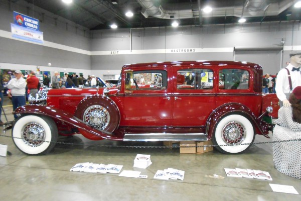 vintage prewar luxury limousine sedan displayed at indoor car show