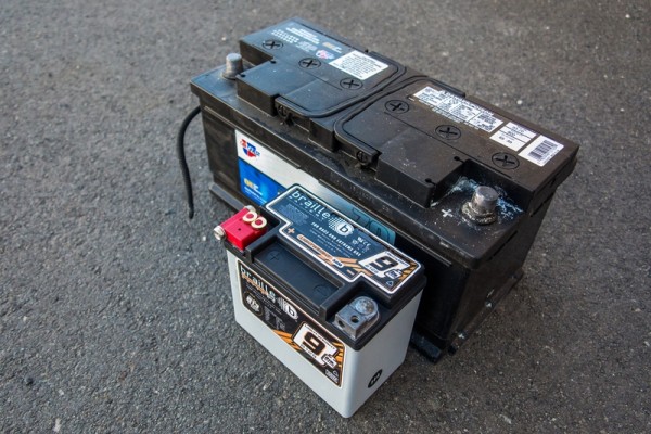 size comparison between a normal car battery and a racing battery