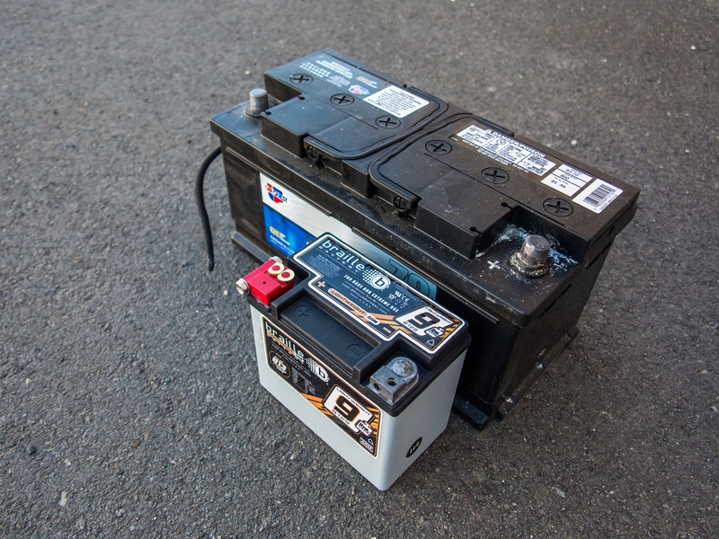 size comparison between a normal car battery and a racing battery
