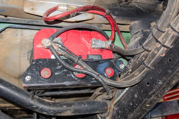 dirty used battery mounted on vehicle