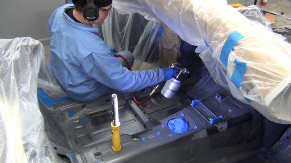 spraying lizardskin coating into a vehicle floor