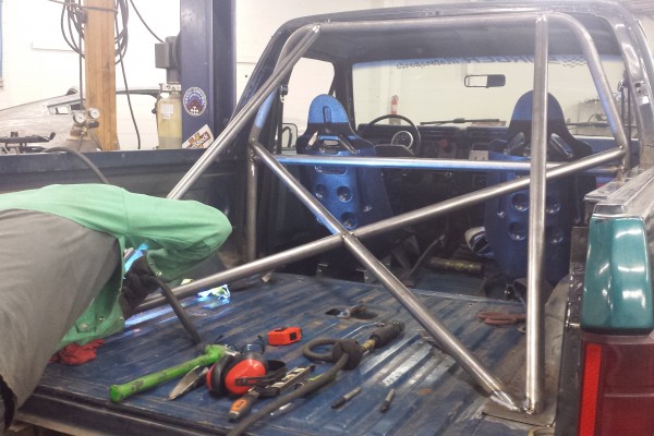welding up a roll cage in a ford bronco race truck