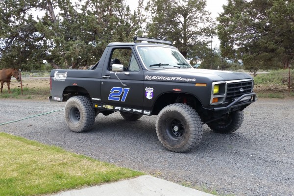 ford bronco race truck in gravel driveway