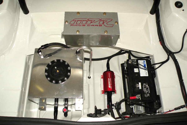 ballast boc, fuel cell, and battery in the trunk of a drag race car