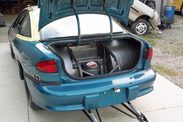 rear trunk of a super stock chevy cavalier with a ballast box