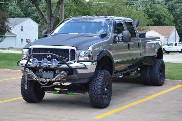 Ford F350 lifted truck with bull bar and dually wheels